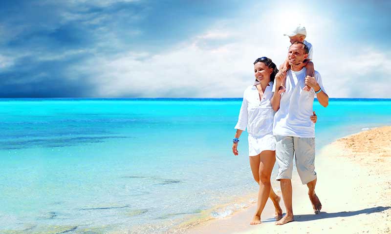 blue marlin cove family walking on grand bahamas beach