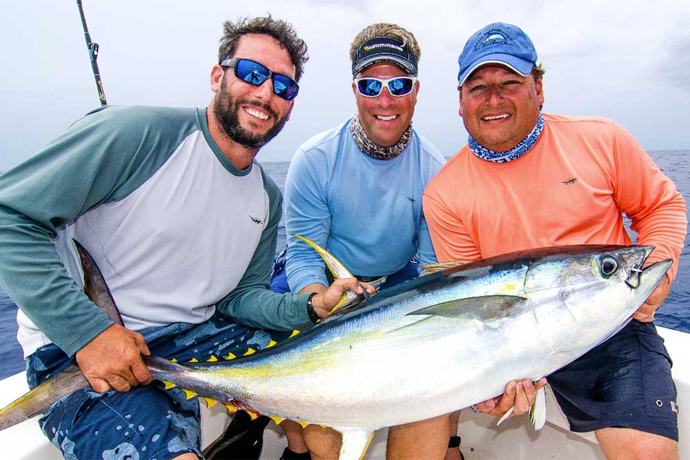 3 men holding fish